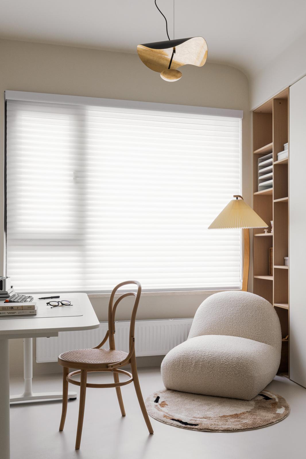 Study corner with layered daylight and lamps
