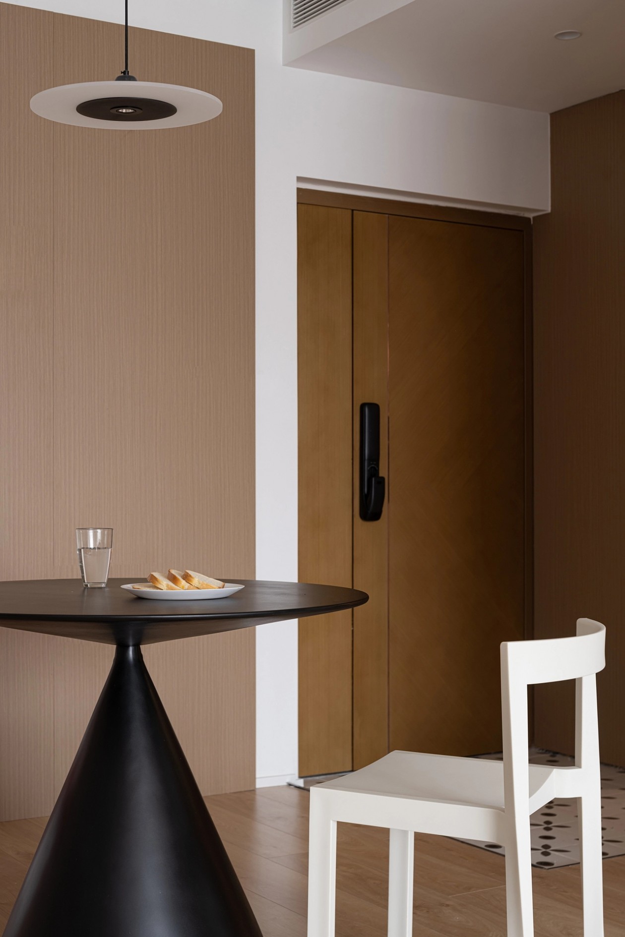 Dining nook with pendant light and warm oak wall panelling