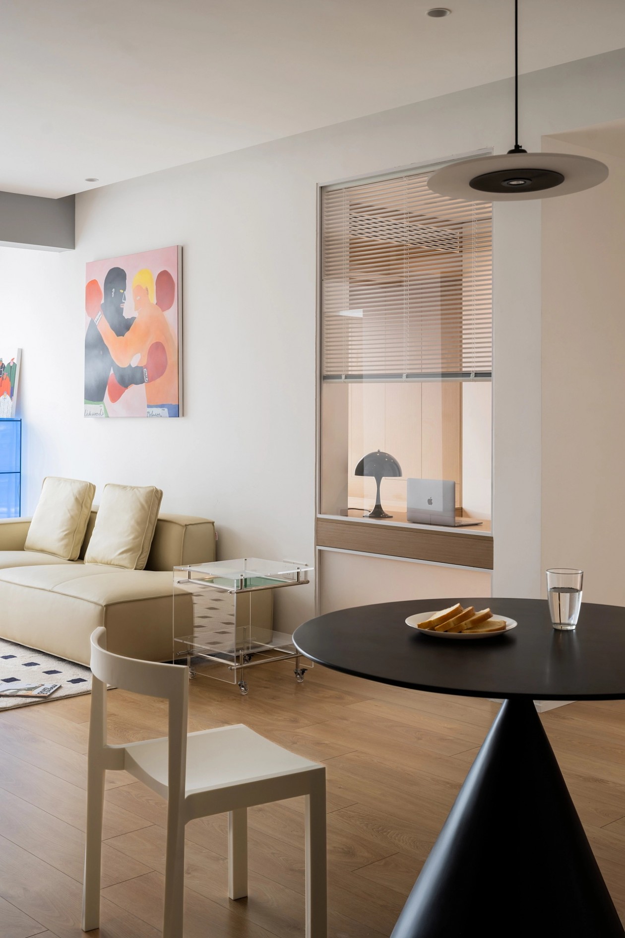 Living room with cream sofa and boxing-themed gallery wall