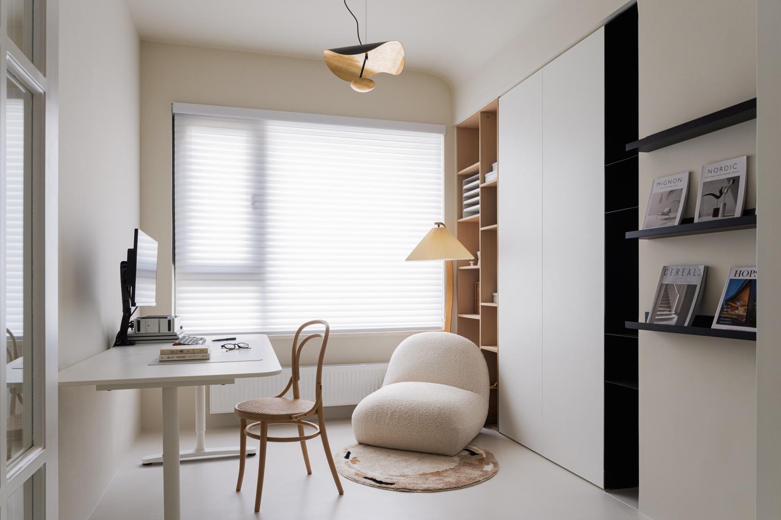 Home study with height-adjustable desk, bentwood chair, bouclé lounge chair and full-height oak and white joinery