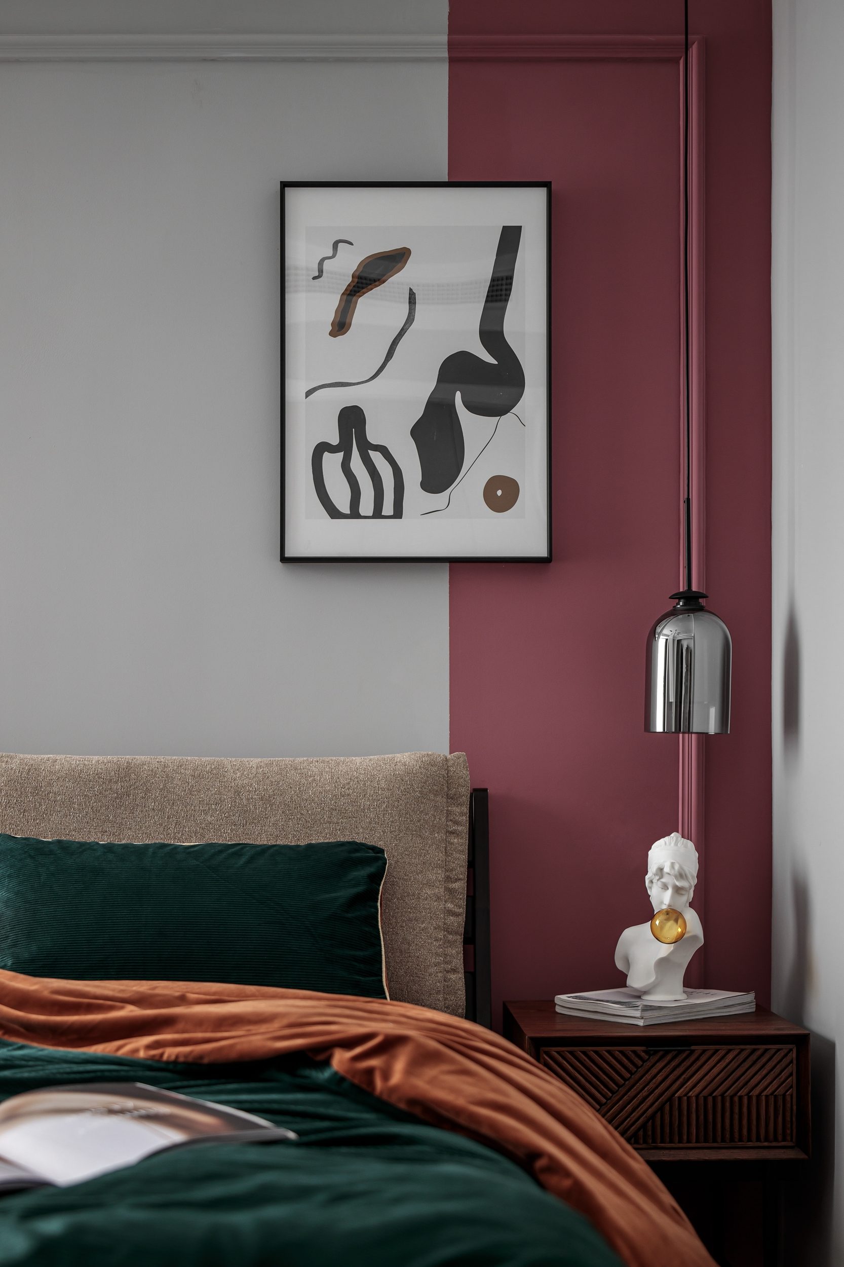 Master bedroom with terracotta and forest green bedding, half-painted wall