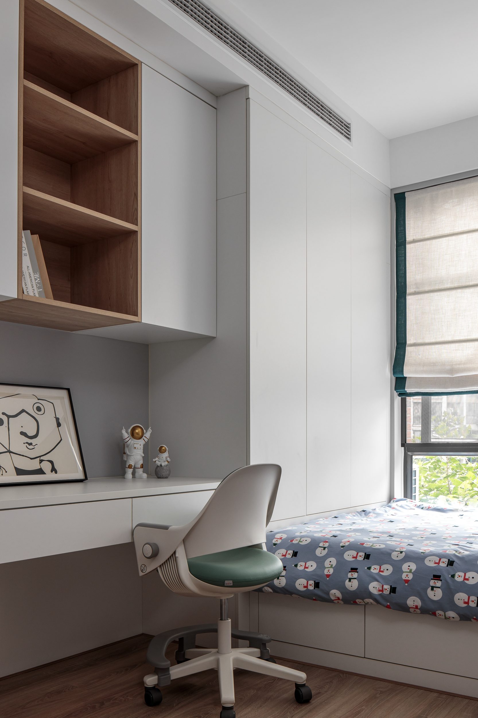 Children's desk and open shelving with astronaut figurines